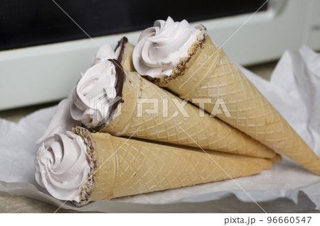 Homemade marshmallows in waffle cones. Homemade zephyr. 96660547