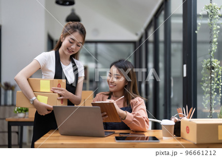 Two Asian woman working together for SME project. Young Owner people startup for Business Online, SME, Delivery Project. Online Business and Small business Concept 96661212
