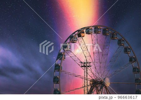 Helsinki, Finland. Very Peri Sky Above Ferris Wheel. Light Violet Colors. Bright Dramatic Yellow Light Purple Sky 96663617