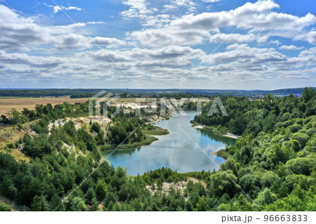Aerial view of a lake in the mining of an open pit for sand and quartz in a forest area in the north of Germany 96663833