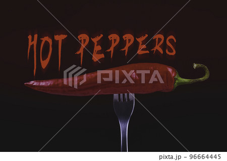 Hot chili peppers on fork. Extra spicy. Mexican food with pepper. Seasonings and spices. Hellish seasoning. Hot chili peppers on fork. Extra spicy. Mexican food with pepper. Seasonings and spices. Hellish seasoning. 96664445