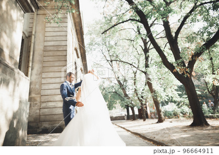 Beautiful caucasian wedding couple just married and dancing their first dance Beautiful caucasian wedding couple just married and dancing their first dance 96664911