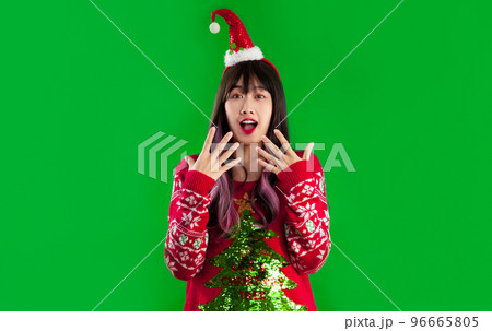 Asian woman in christmas theme costume posing wow, shocked and surprised face green screen background. 96665805