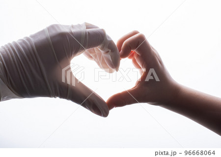 Putting on latex gloves on hands for protection make heart shape Putting on latex gloves on hands for protection make heart shape 96668064
