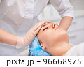 woman receiving facial massage at spa salon 96668975