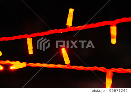 Lights of Christmas garland close-up on black background. 96671242