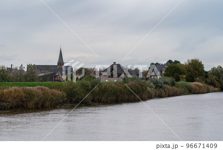 Berlare, East Flemish Region, Belgium - View over the River Scheldt, the banks and the village in the background 96671409