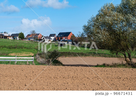 Asse ter Heide, Flemish Brabant  - Harvested farmland and residential houses at the Flemish countryside 96671431