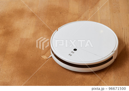 Robot vacuum cleaner cleans the very dirty dusty floor of the apartment at a certain time. Robot vacuum cleaner cleans the very dirty dusty floor of the apartment at a certain time. 96671500