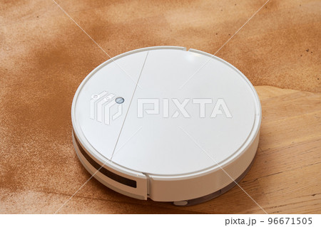 Robot vacuum cleaner cleans the very dirty dusty floor of the apartment at a certain time. Robot vacuum cleaner cleans the very dirty dusty floor of the apartment at a certain time. 96671505