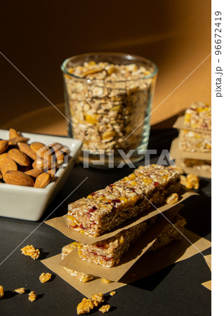 Homemade Granola energy bar. Variety of homemade protein granola breakfast bars ingredients nuts, raisins dried cherries and chocolate. Healthy nutrition eating Gluten free cereal dieting snack super Homemade Granola energy bar. Variety of homemade protein granola breakfast bars ingredients nuts, raisins dried cherries and chocolate. Healthy nutrition eating Gluten free cereal dieting snack super 96672419