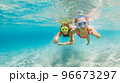 Kids in snorkeling mask dive underwater in blue sea lagoon 96673297