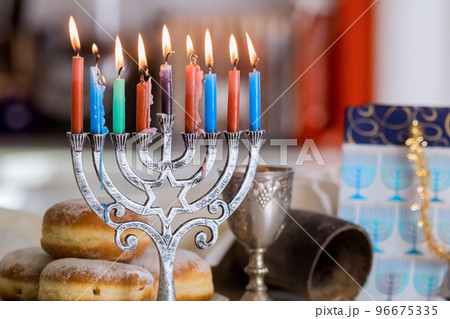 Hanukkah celebration Judaism tradition family religious holiday symbols lighting hanukkiah menorah candles 96675335