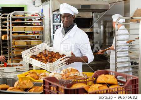 African baker carrying bread in box 96676682