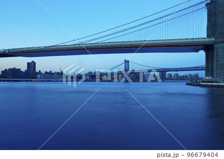 Brooklyn Bridge by night with skyscrapers, New York panoramic view of Manhattan skyline Brooklyn Bridge by night with skyscrapers, New York panoramic view of Manhattan skyline 96679404