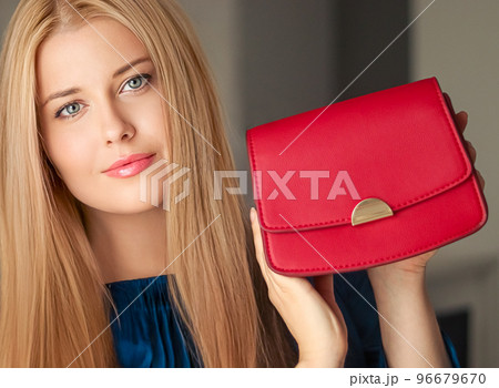 Fashion and accessories, happy beautiful woman holding small red handbag with golden details as stylish accessory and luxury shopping concept 96679670