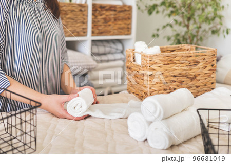 female hands neatly folded white clean towels in case box use Japanese organizing method female hands neatly folded white clean towels in case box use Japanese organizing method 96681049