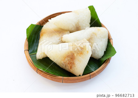 Grilled sticky rice in banana leave with mung beans filling Grilled sticky rice in banana leave with mung beans filling 96682713