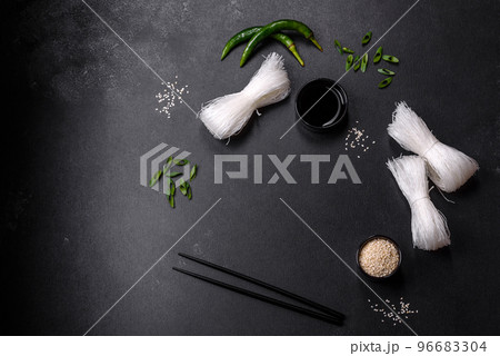 Tasty dish of Asian cuisine with rice noodles, chicken, asparagus, pepper, sesame seeds and soy sauce Tasty dish of Asian cuisine with rice noodles, chicken, asparagus, pepper, sesame seeds and soy sauce 96683304