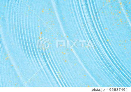 Blue liquid gel smudge and strokes with gold glitter particles. Skincare and moisture cosmetic products. Clear serum background. Cosmetic textures close up. 96687494