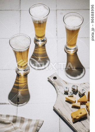 Beer and cheese. Glass of beer with cheese. Ale and food concept Beer and cheese. Glass of beer with cheese. Ale and food concept 96688996