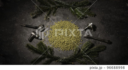 hope for a granular on a dark background with male instruments. An ingredient for industrial beer production. Decorations from the Christmas tree 96688998