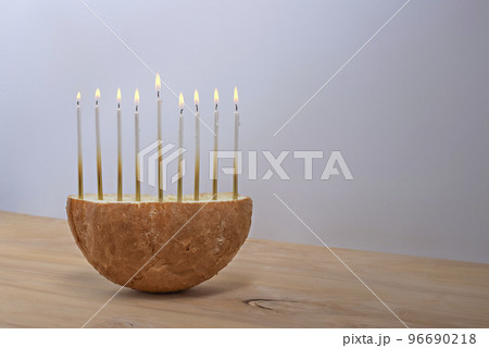Creative Hanukkah menorah on a wooden table. 96690218
