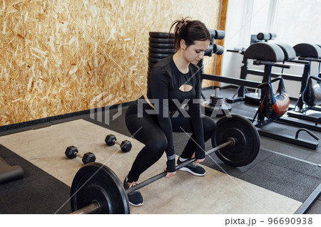 Strong brunette female doing crossfit workout 96690938