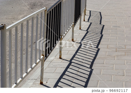 Handrail by road. Pedestrian barrier. Fence along road. Fencing details Handrail by road. Pedestrian barrier. Fence along road. Fencing details 96692117