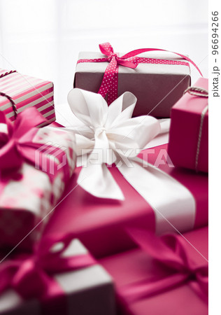 Holiday gifts and wrapped luxury presents, pink gift boxes as surprise present for birthday, Christmas, New Year, Valentines Day, boxing day, wedding and holidays shopping or beauty box delivery Holiday gifts and wrapped luxury presents, pink gift boxes as surprise present for birthday, Christmas, New Year, Valentines Day, boxing day, wedding and holidays shopping or beauty box delivery 96694266