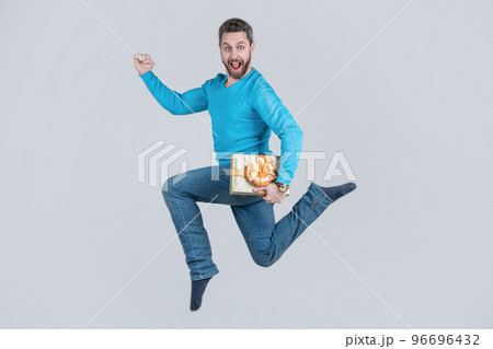 jumping handsome man with present box. businessman giving birthday gift. energetic unshaven man 96696432