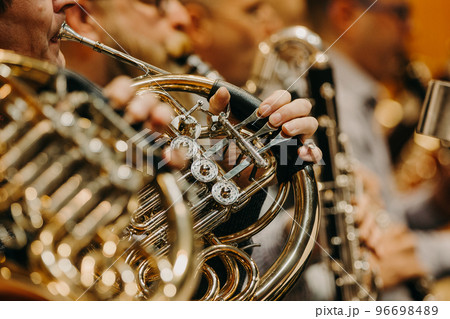 Close up of hand on the french horn during philharmonic concert, art concept 96698489