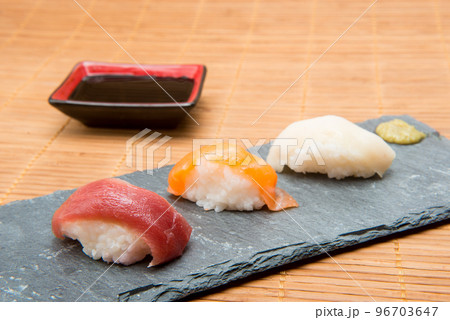 Tuna and salmon sushi on stone with soy sauce Tuna and salmon sushi on stone with soy sauce 96703647