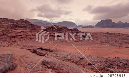 Red orange Mars like landscape in Jordan Wadi Rum desert, mountains background, overcast morning. This location was used as set for many science fiction movies Red orange Mars like landscape in Jordan Wadi Rum desert, mountains background, overcast morning. This location was used as set for many science fiction movies 96703913