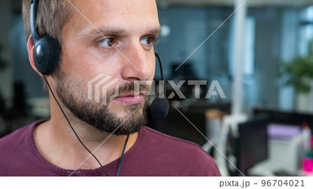Caucasian bearded man with a headset. Male call center worker Caucasian bearded man with a headset. Male call center worker 96704021