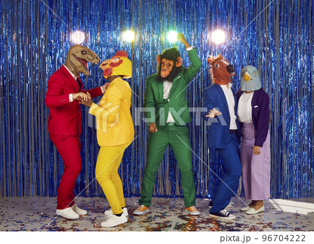 Group of showmen fool around and dance in a club on a shiny blue background. 96704222