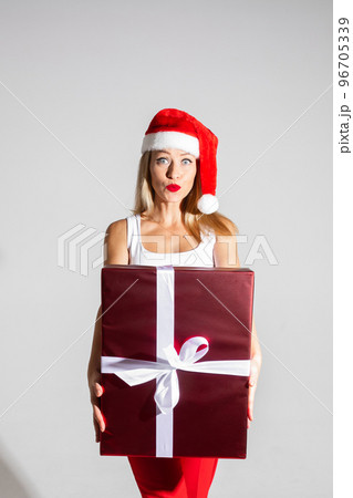 handsome woman with red and white christmas hat 96705339