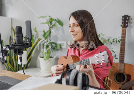 female musician and podcaster creates audio and video content for social media. confident European woman  96706042