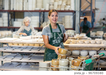 Cheerful young woman ceramist in workshop 96709380