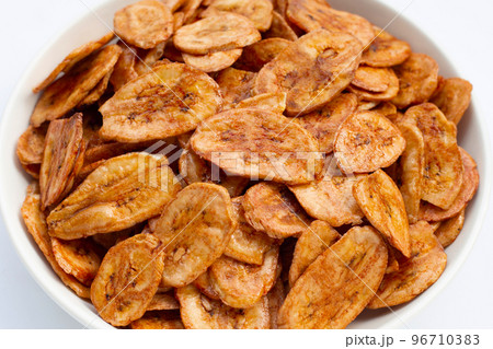 Banana chips on white background. 96710383