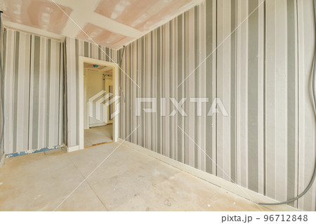 Empty room with windows and radiator in daylight 96712848
