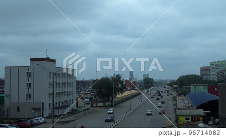 Car traffic on a wide highway and gloomy sky, city panorama Car traffic on a wide highway and gloomy sky, city panorama 96714082