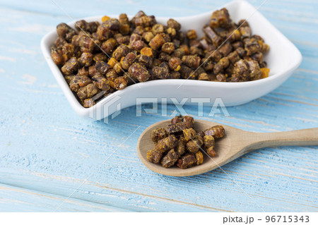 bee parchment in a wooden spoon, close-up. Vitamins, benefits. bee parchment in a wooden spoon, close-up. Vitamins, benefits. 96715343