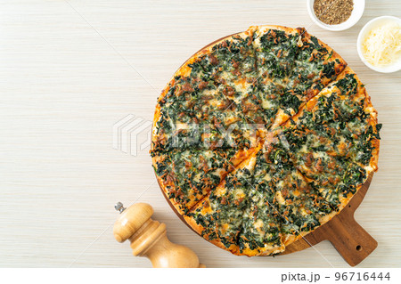 spinach and cheese pizza on wood tray 96716444