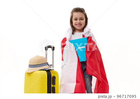 Adorable smart preschooler child, a lovely little girl with textbook, wrapped in Canadian flag, happy to immigrate to Canada to study, isolated on white background with free space for your advertising Adorable smart preschooler child, a lovely little girl with textbook, wrapped in Canadian flag, happy to immigrate to Canada to study, isolated on white background with free space for your advertising 96717095