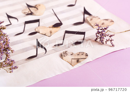 The concept of love for music. Paper notes and hearts on a music sheet. The concept of love for music. Paper notes and hearts on a music sheet. 96717720