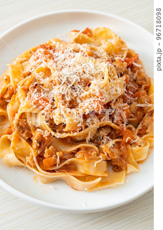 Homemade pasta fettuccine bolognese with cheese Homemade pasta fettuccine bolognese with cheese 96718098