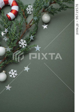 Christmas green background. Fir tree branches, seasonal ornament candy canes. Creative flat lay, top view copy space 96719576