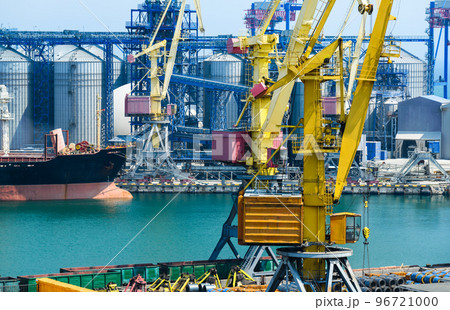industrial infrastructure of the seaport, the sea, cranes and railway wagons, grain silo, bulk carrier vessel and grain storage elevators, the concept of sea cargo transportation industrial infrastructure of the seaport, the sea, cranes and railway wagons, grain silo, bulk carrier vessel and grain storage elevators, the concept of sea cargo transportation 96721000