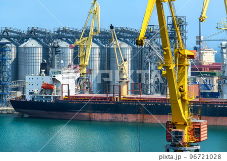 industrial seaport infrastructure, sea, cranes and dry cargo ship, grain silo, bulk carrier vessel and grain storage elevators, concept of sea cargo transportation industrial seaport infrastructure, sea, cranes and dry cargo ship, grain silo, bulk carrier vessel and grain storage elevators, concept of sea cargo transportation 96721028